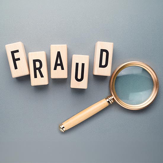 FRAUD Blocks and magnifying glass