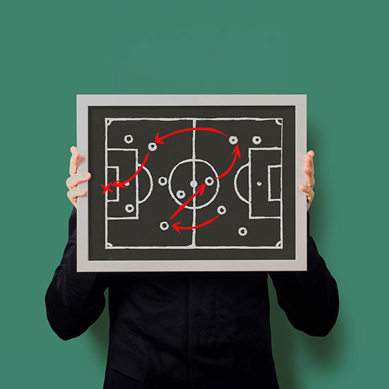 man holding a layout of a field, with a play on it